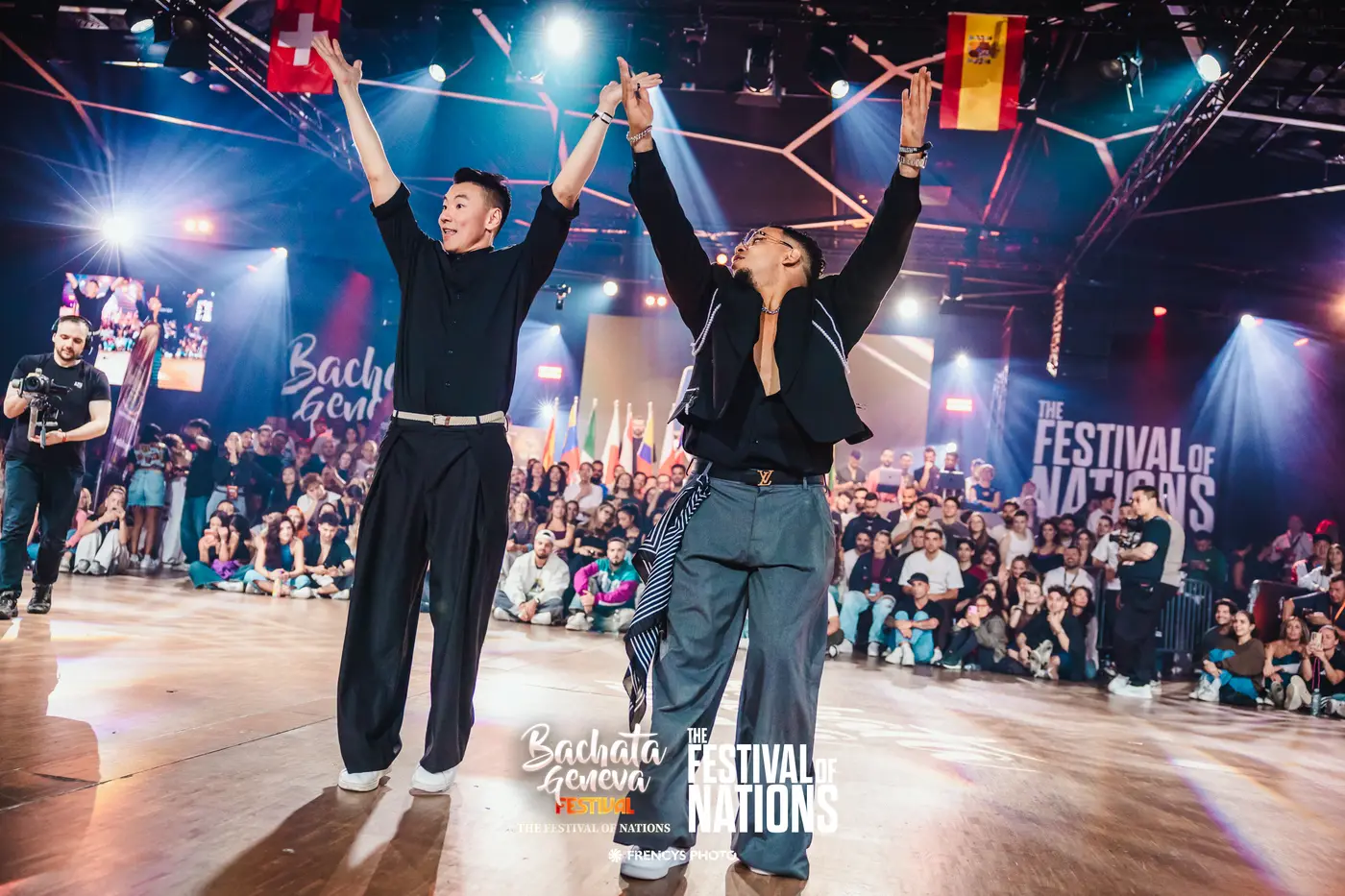 Two finalists raising their arms on the floor of the World Cup Finals 2026